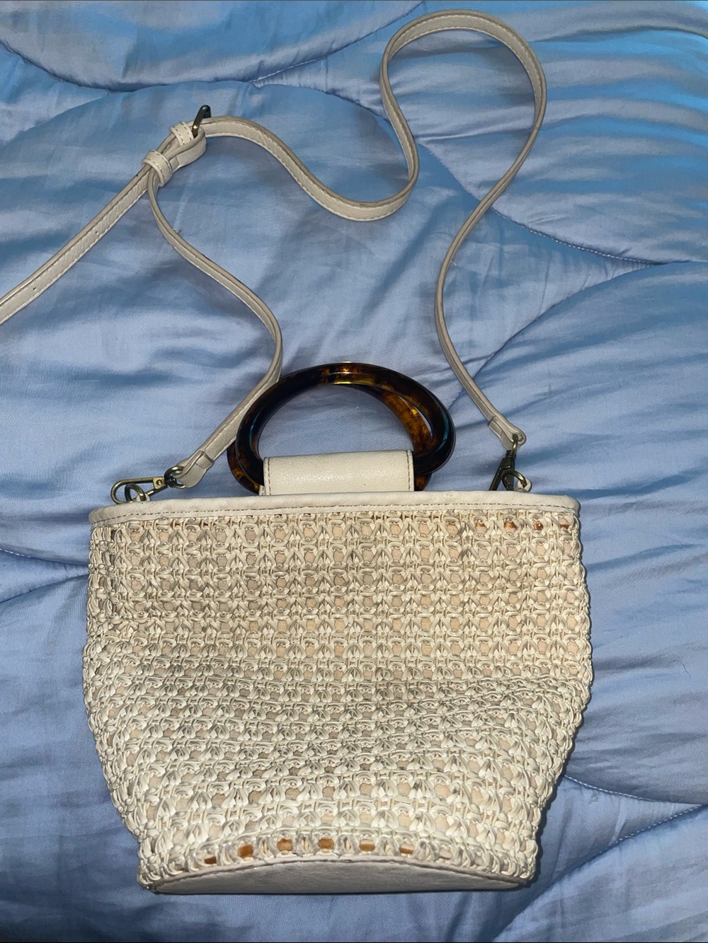 Anthropologie Westlyn woven bucket bag featuring resin handles.